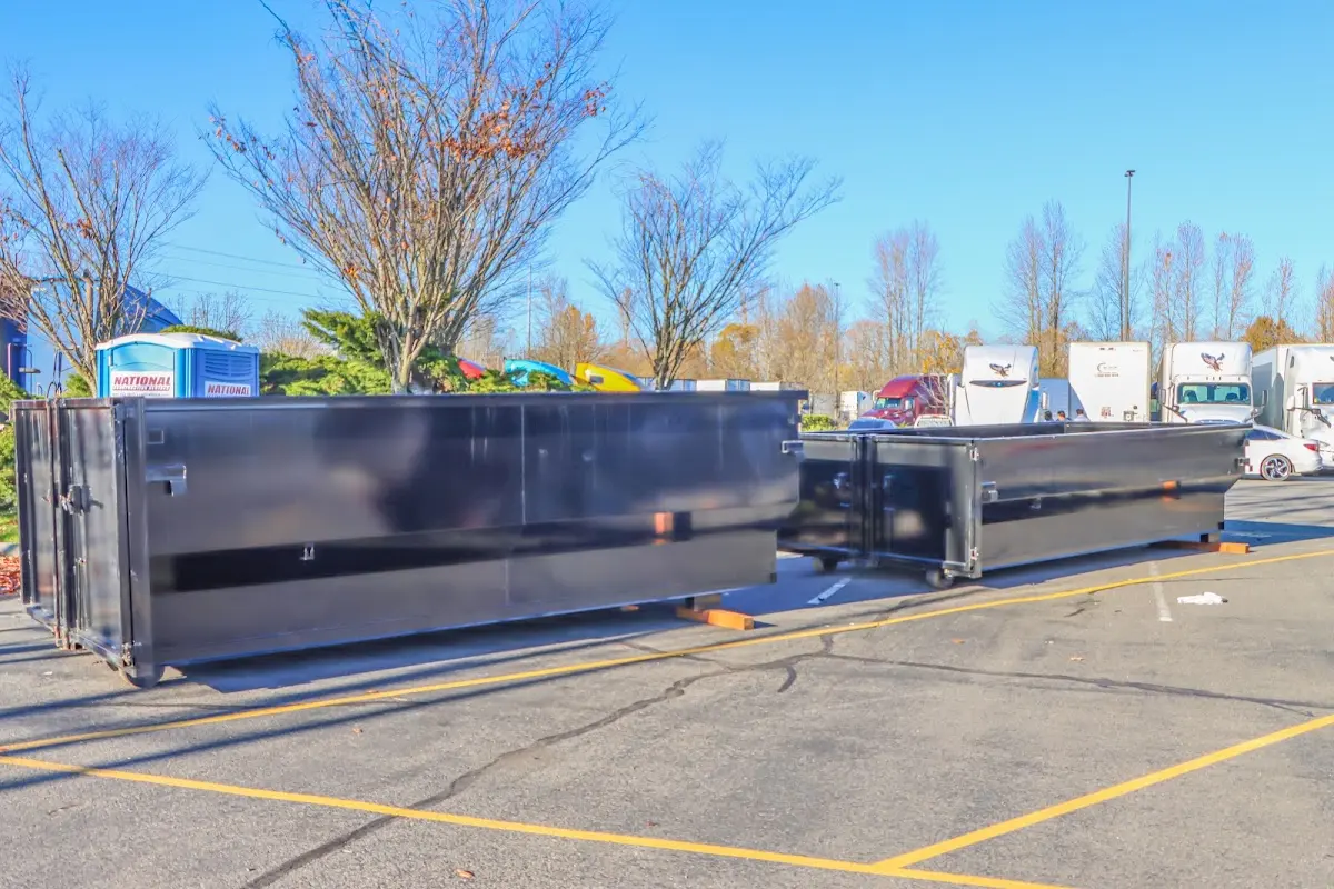 Professional dumpster rental service with roll-off container on residential driveway in San Antonio